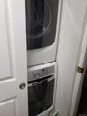 Laundry room featuring stacked washer / dryer and laundry area