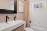 Full bath featuring vanity and shower / bathtub combination with curtain