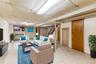 Living area with a drop ceiling and stairs