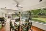 Covered and screened lanai offering the perfect space for outdoor dining, entertaining, and enjoying views of the pool and grounds