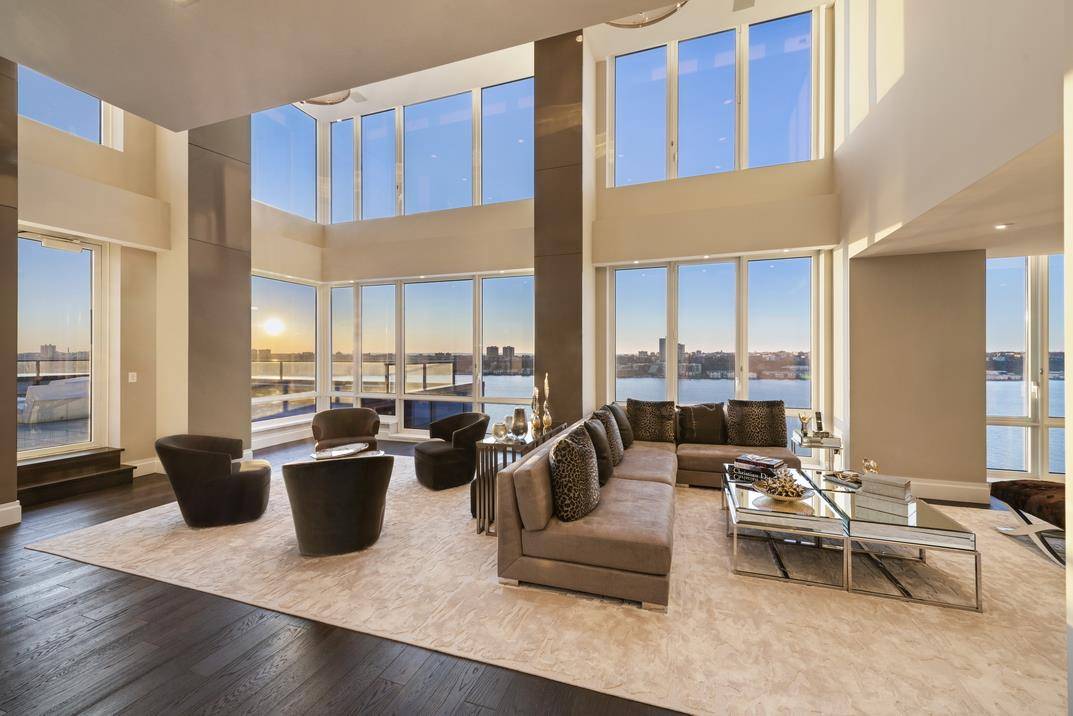 A palatial gut renovated duplex mansion boasting direct Hudson River views and one of the largest private outdoor pools in New York City !