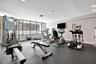 Fully equipped fitness center featuring cardio and strength-traininng equipment, offering everything you need to stay active without leaving home