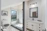 Full bathroom featuring a stall shower, toilet, and vanity