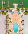 This is an aerial view of the pool at Barefoot Beach. There are lots of lounge chairs for your enjoyment in the sun. The pool is heated.