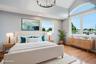 Bedroom featuring vaulted ceilings with an arched window, hardwood flooring, and recessed lighting