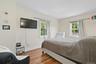 Bedroom with wood finished floors and baseboards