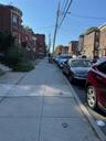 View of asphalt road featuring street lighting, sidewalks, and a residential view
