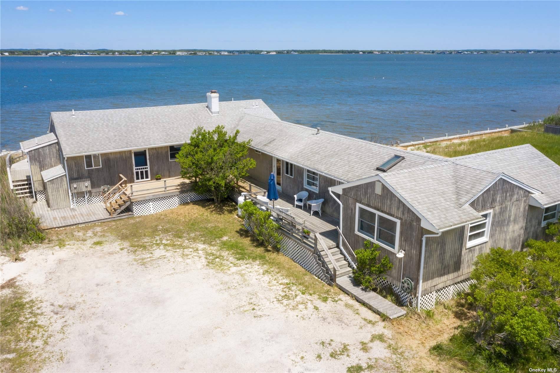 Bayfront beach living in Westhampton Dunes at this unique compound with ocean beach access across the street !