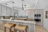 Spectacular kitchen w/ custom bleached walnut veneer cabinetry by renowned Chicago based millworker. Grain matches from top to bottom. Taj mahal quart