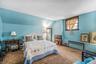 Bedroom featuring radiator, carpet, and lofted ceiling