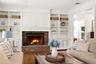 Wood buring fireplace and custom built-in cabinetry are the rooms focal point.