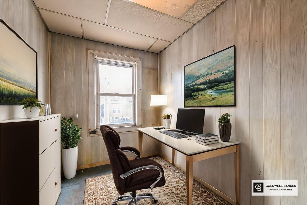 Office featuring wood walls and a paneled ceiling