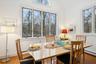 Dining area with baseboard heating, vaulted ceiling, and hardwood / wood-style flooring