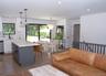Kitchen with gray cabinetry, decorative backsplash, a breakfast bar area, recessed lighting, and white cabinetry