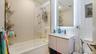 Full bath with vanity, shower / washtub combination, and backsplash