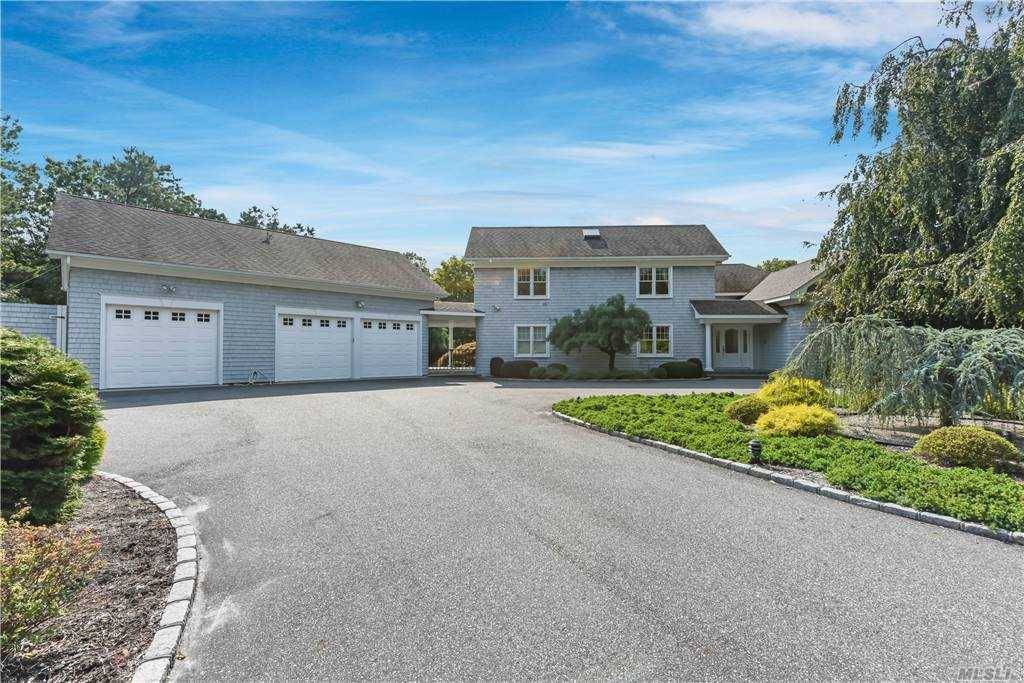 Enjoy this beautiful Contemporary Home in Quogue Village, sited on a lovely wooded 1.