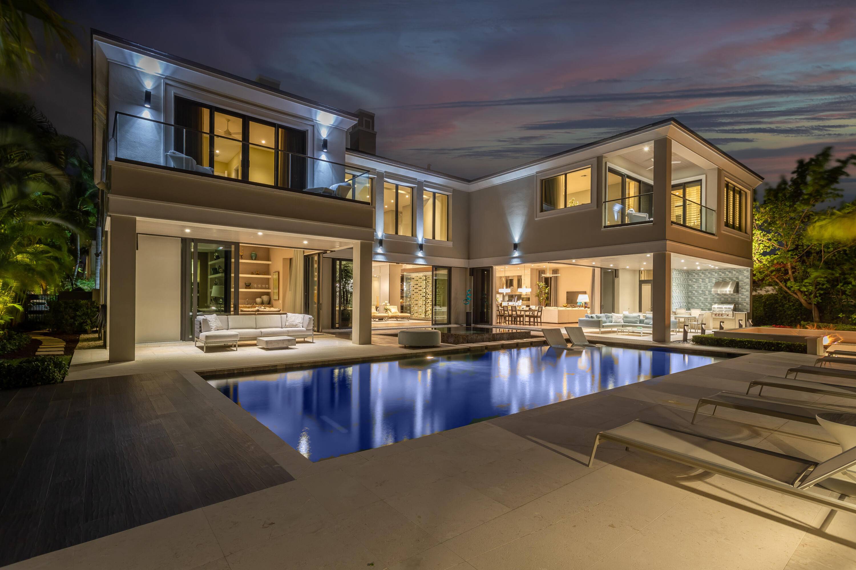 Transitional contemporary two story deep water waterfront residence features Intracoastal access and 24 7 gate and water patrol security with private roads.