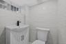 Bathroom with vanity and tile walls