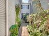 Cobblestone path from cul-de-sac, mature professional landscaping.
