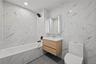 Bathroom featuring tile walls, vanity, a combined bath / shower with marble appearance, recessed lighting, and dark tile patterned flooring