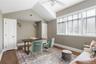 Home office featuring a ceiling fan, baseboards, dark wood finished floors, lofted ceiling, and visible vents