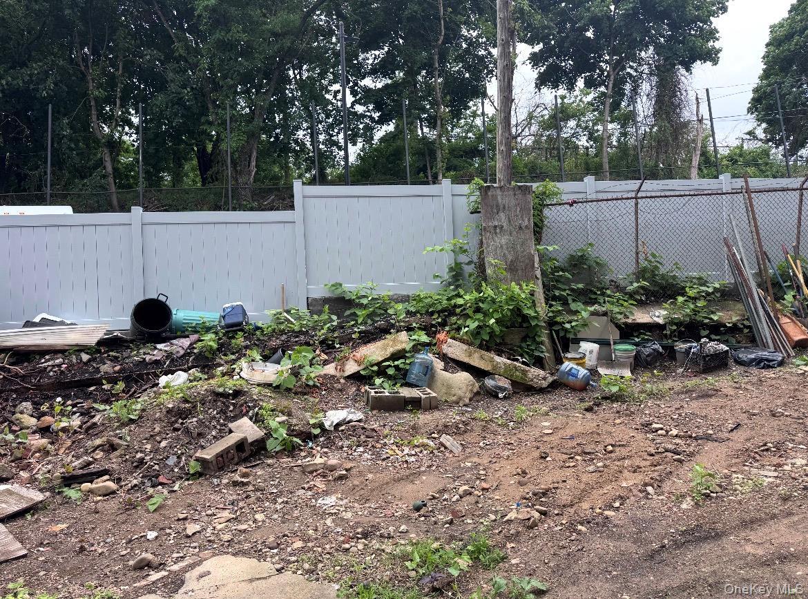 Fenced backyard with a vegetable garden
