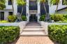 A stately greeting to all who arrive surrounded by natural Florida landscaping, lush and tropical