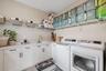 Laundry Room w so much storage. Cabinetry and shelves