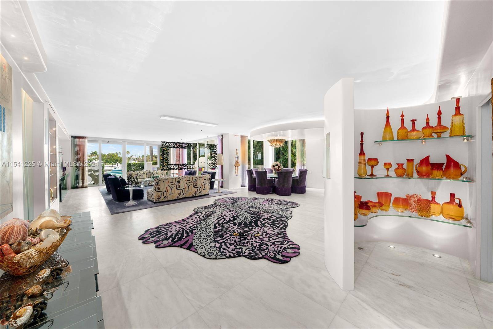 This spectacular one of a kind 2 story townhouse is located in Harborview overlooking Fisher Island s inner marina.