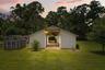 13-stall center-aisle barn featuring matted stalls, automatic waterers, hot water access, and upgraded electrical service