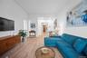 Living room with ornamental molding and light wood finished floors