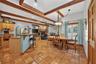 Open-Concept Gourmet Kitchen, Dining & Family Room with Exposed Wood Beams