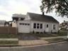 Front of home, fenced in yard.