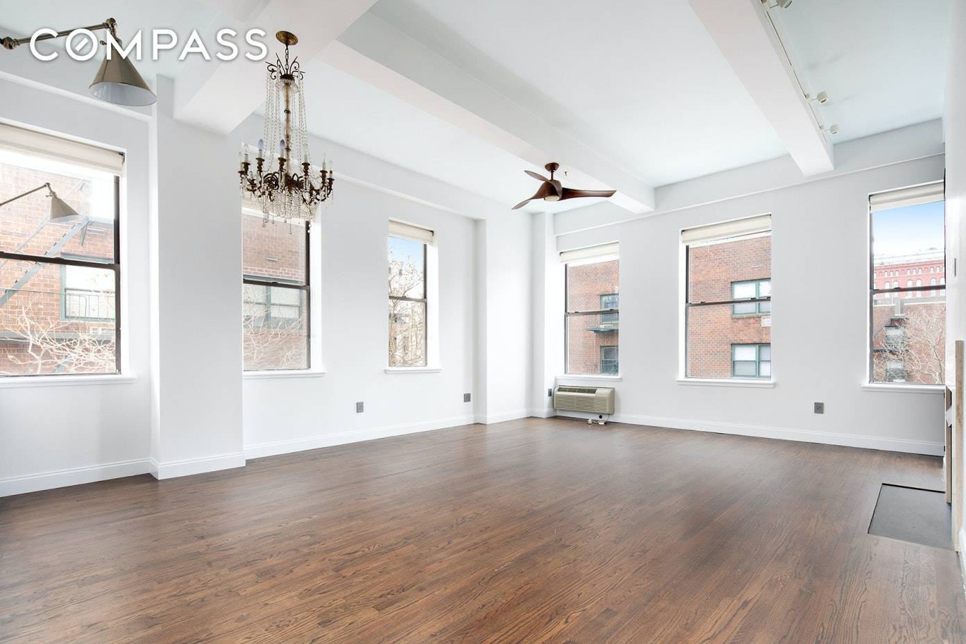 PERRY STREET PERFECTION. Bask in the sunlight in this glorious corner condo loft with towering ceilings, wood burning fireplace, two bedrooms, two baths, and superb storage.