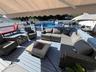 Expansive outdoor deck with a retractable awning, fire pit, and privacy fencing