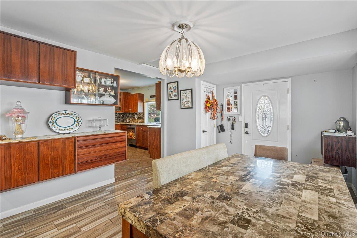 Dining space featuring wood tiled floors and hanging lights