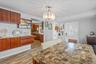 Dining space featuring wood tiled floors and hanging lights
