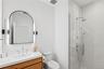 Full bathroom featuring a shower stall and vanity