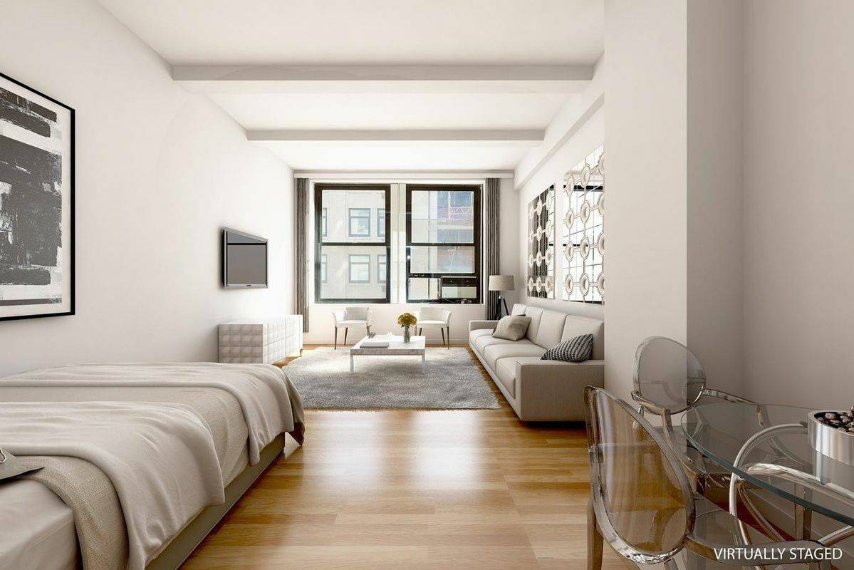 Sun Flooded Renovated Loft with Massive Windows and 11 1 2 ft ceilings with bonus dressing area in a full service iconic building in Prime Noho Greenwich Village.