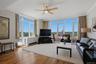 Expansive living area with wood-finish flooring and large windows