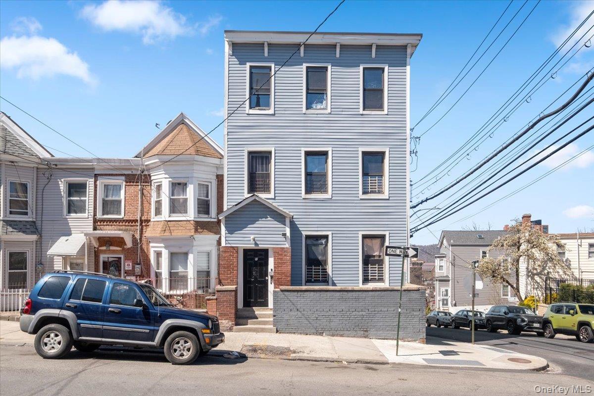 View of front of home featuring brick siding and a residential view