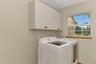 Laundry room with sink is right off the garage area and also has the whole house vacuum equipment