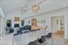 Dining area with chandelier and recessed lighting, off kitchen and living room