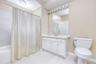 Full Bathroom featuring light tile patterned flooring, vanity, and shower/bath combination with curtain